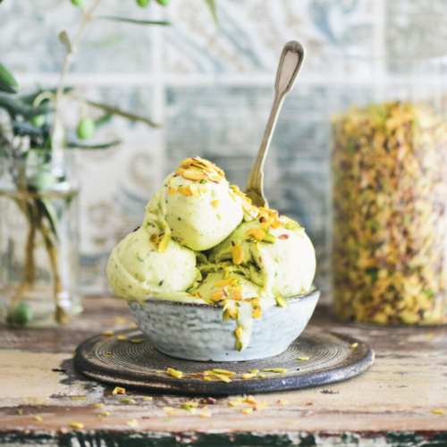 Homemade pistachio ice cream in a bowl, topped with crushed pistachios – gluten-free, dairy-free, and naturally sweetened.