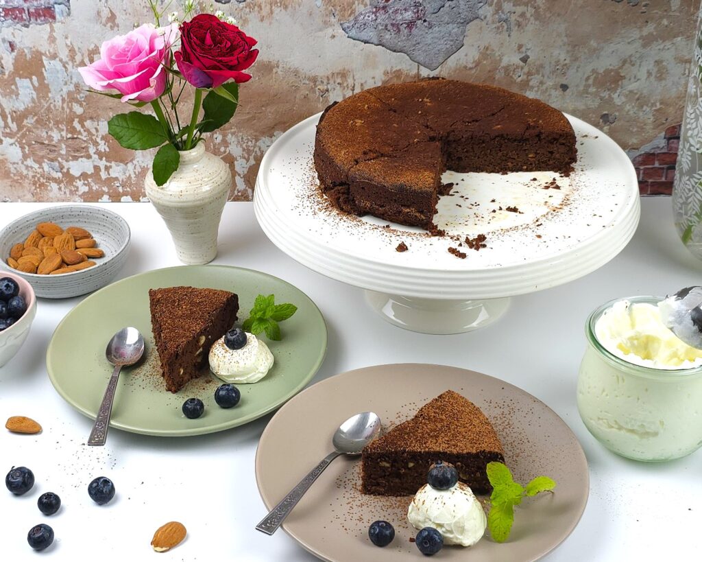 capese cake in two plates, garnished with yoghurt and blueberries