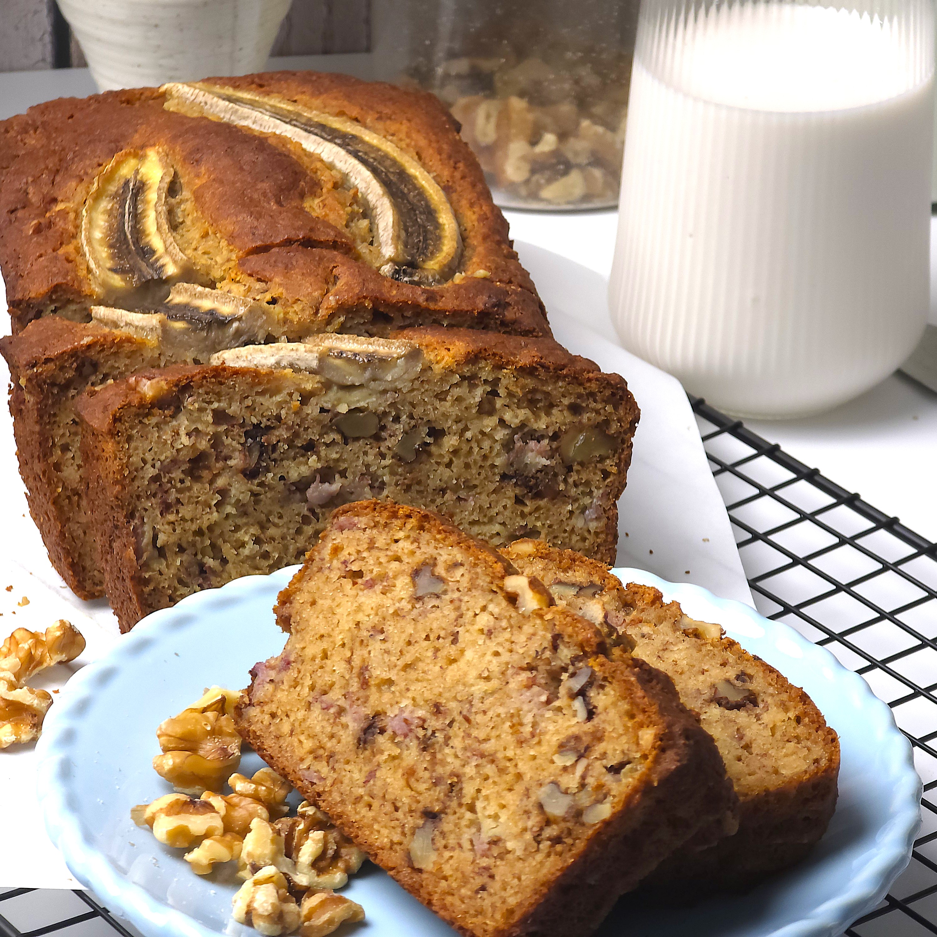  sliced gluten-free no sugar banana bread next to a blue plate with banana bread slices