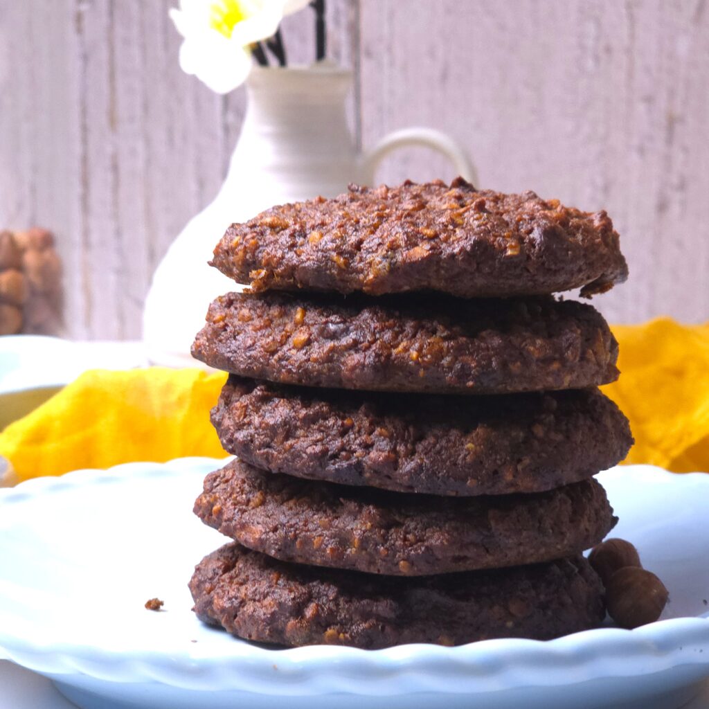 a close look to flourless hazelnut chocolate cookies in a blue plate