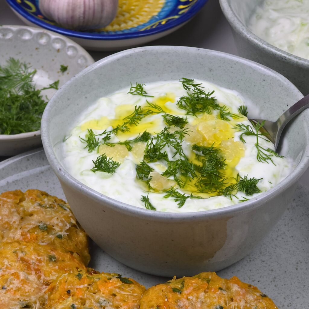 close look of creamy tzatziki sauce in stoneware bowl