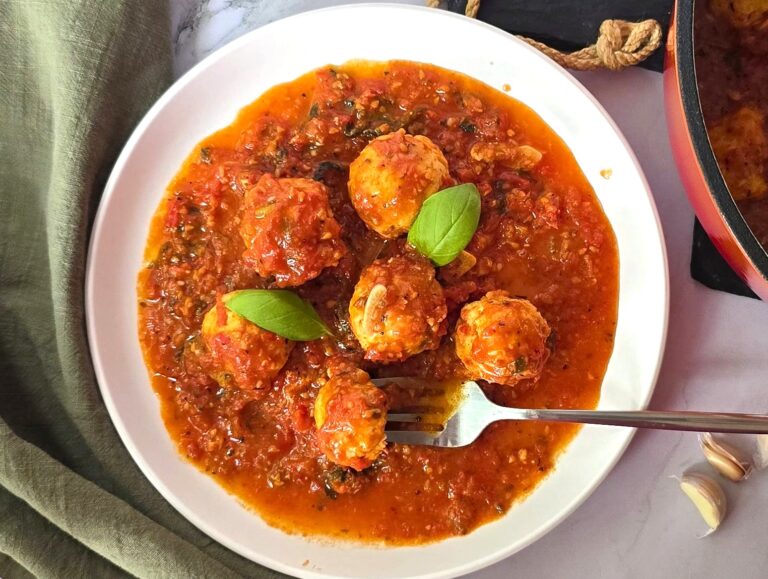 chicken meatballs in marinara sauce in white ceramic plate