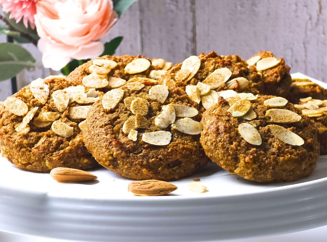 a close look of no sugar almond cookies on a white cake stand