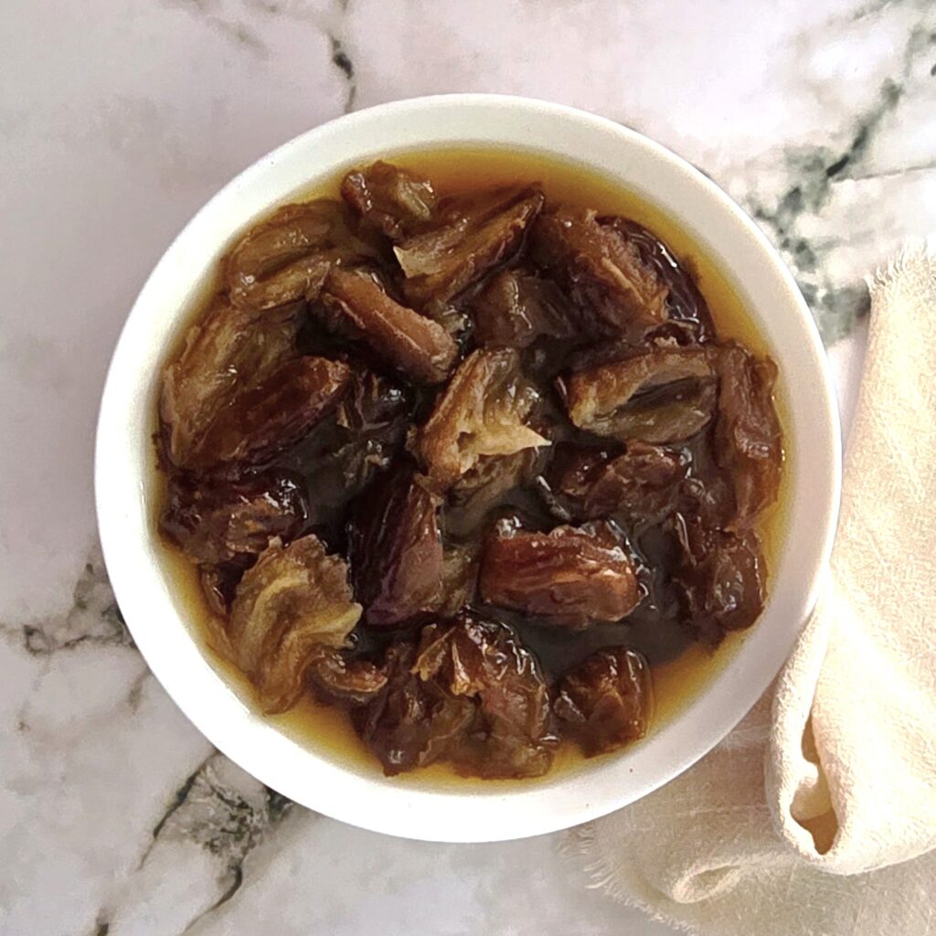 soaked dates in a white bowl