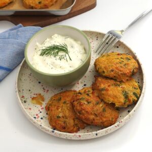 chickpea patties in a dotted white plate served with homemade yoghurt garlic dip