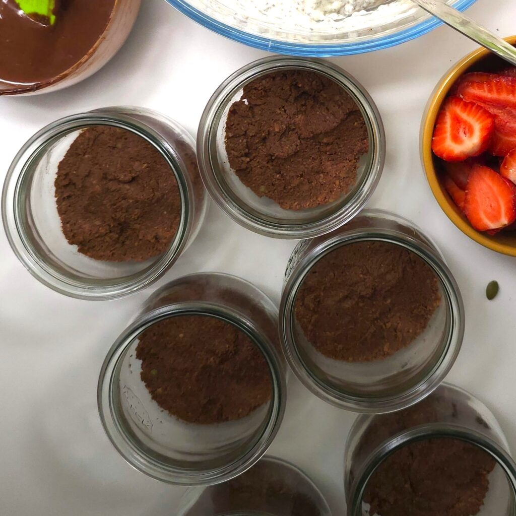 jars with the bottom layer of strawberry parfait