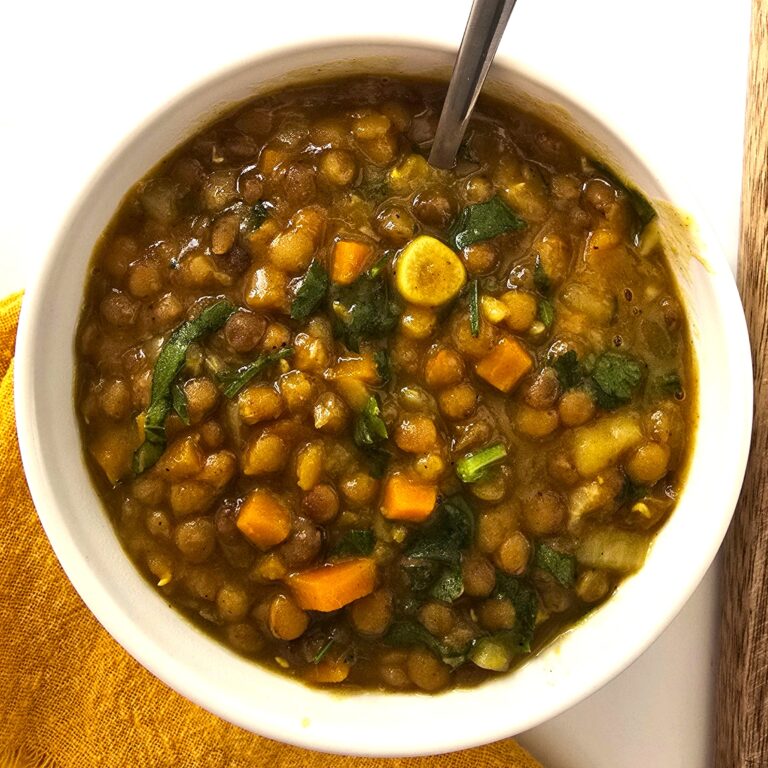 lentil soup in a white bowl and spoon