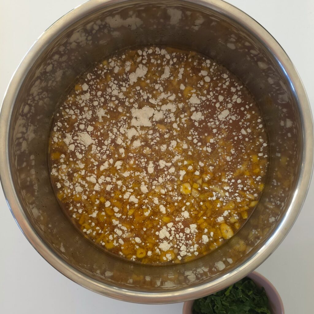 an instant pot with mixed lentil soup ingredients with sprinkled rice flour on the top