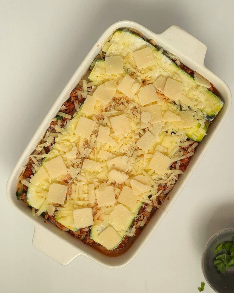 healthy lasagna in a white ceramic baking dish ready for bake