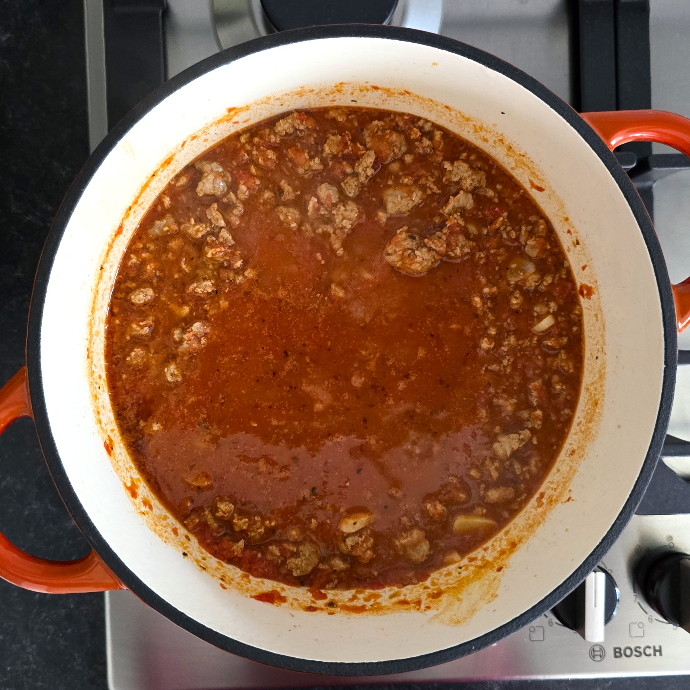 homemade tomato pasta sauce with garlic and mince in a deep pot