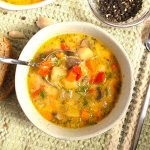 vegetable soup in a bowl and spoon