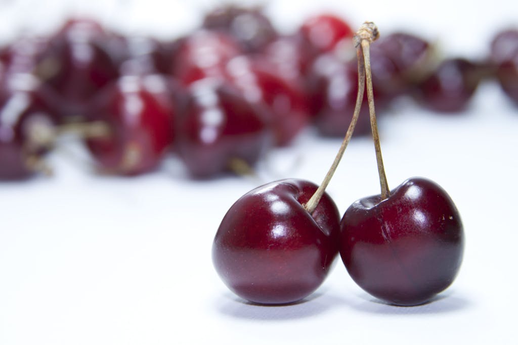 Vibrant close-up of fresh red cherries, ideal for cherry yogurt chia parfait recipe, showcasing their juicy and sweet appearance.