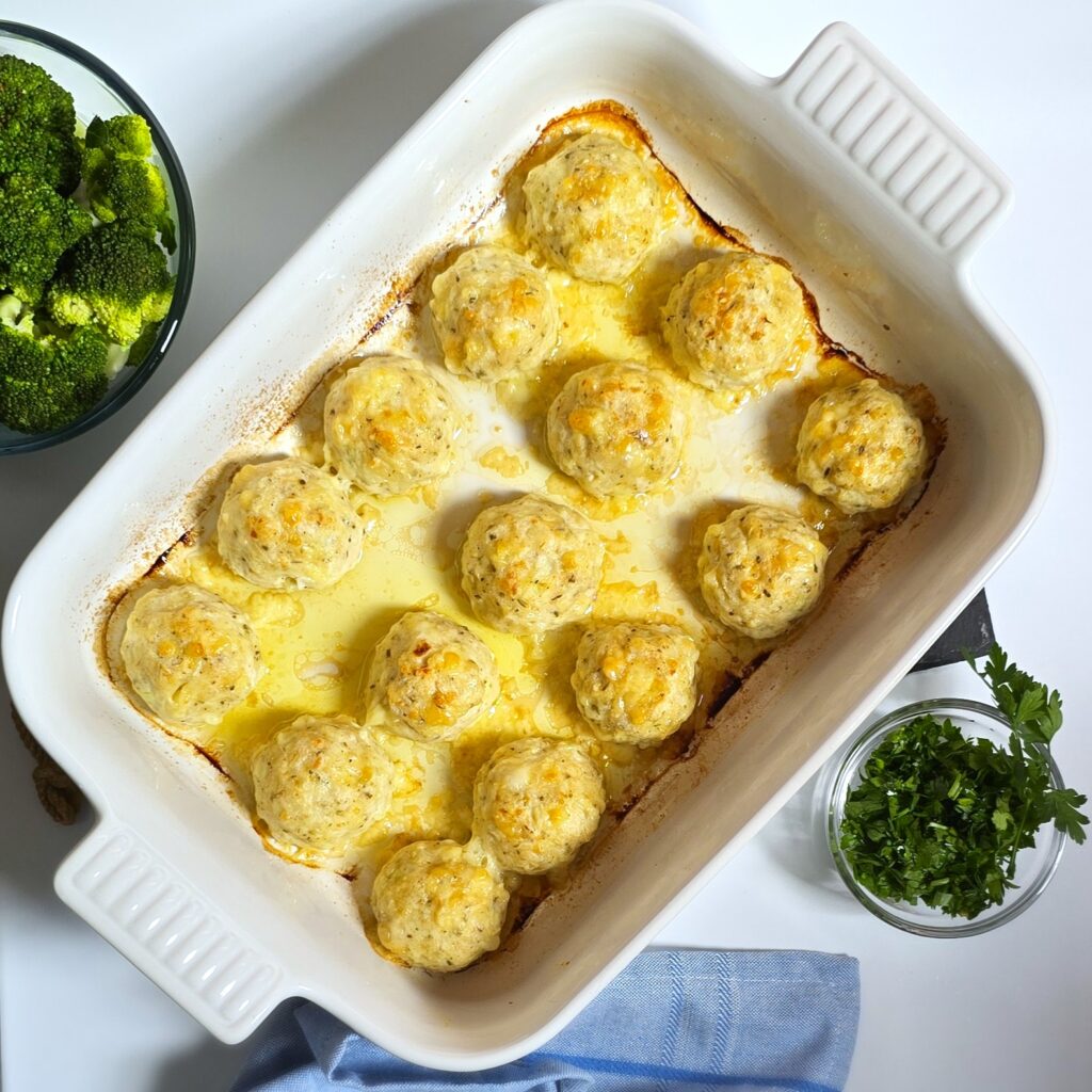 baked meatballs in a white ceramic baking dish