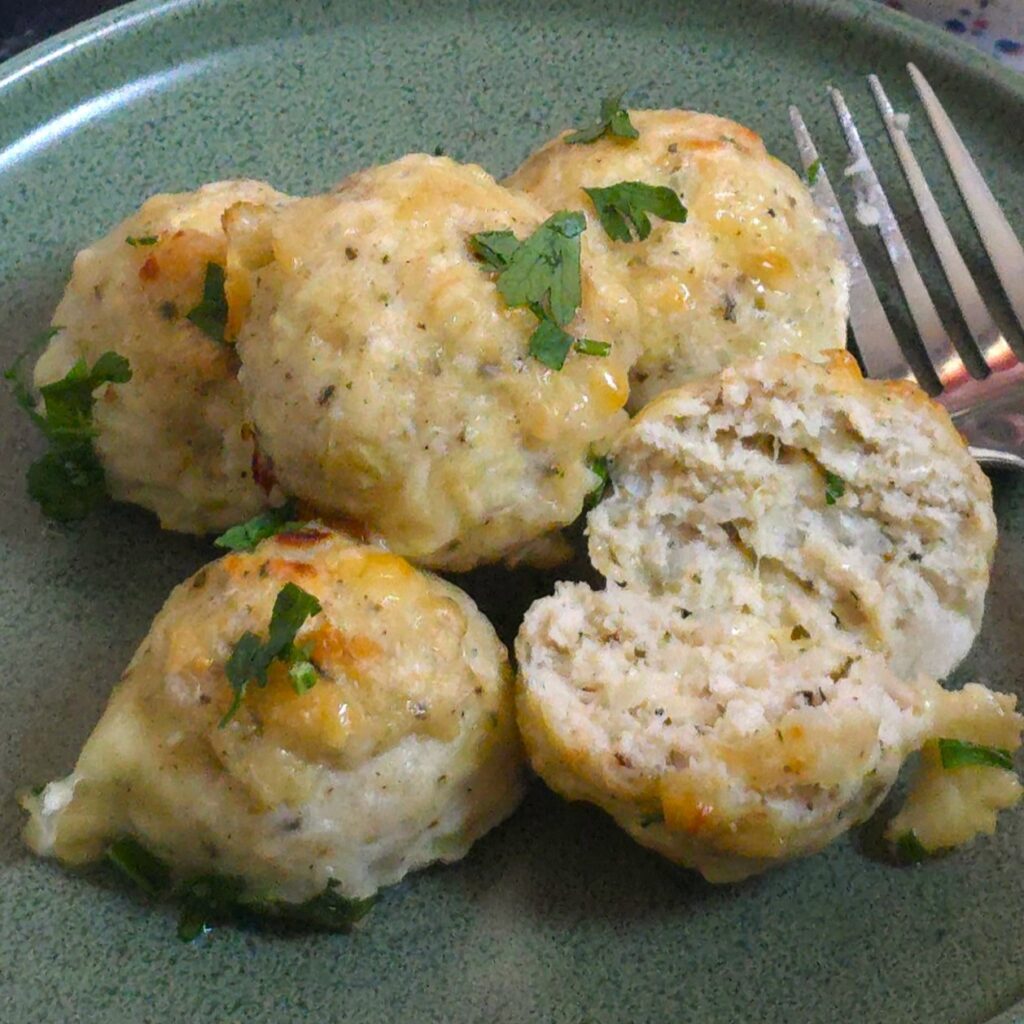 A close look of cheesy chicken meatballs with herbs.