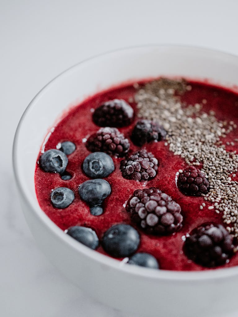 Fresh berry smoothie bowl with chia seeds, a healthy and colorful fibre food breakfast option.