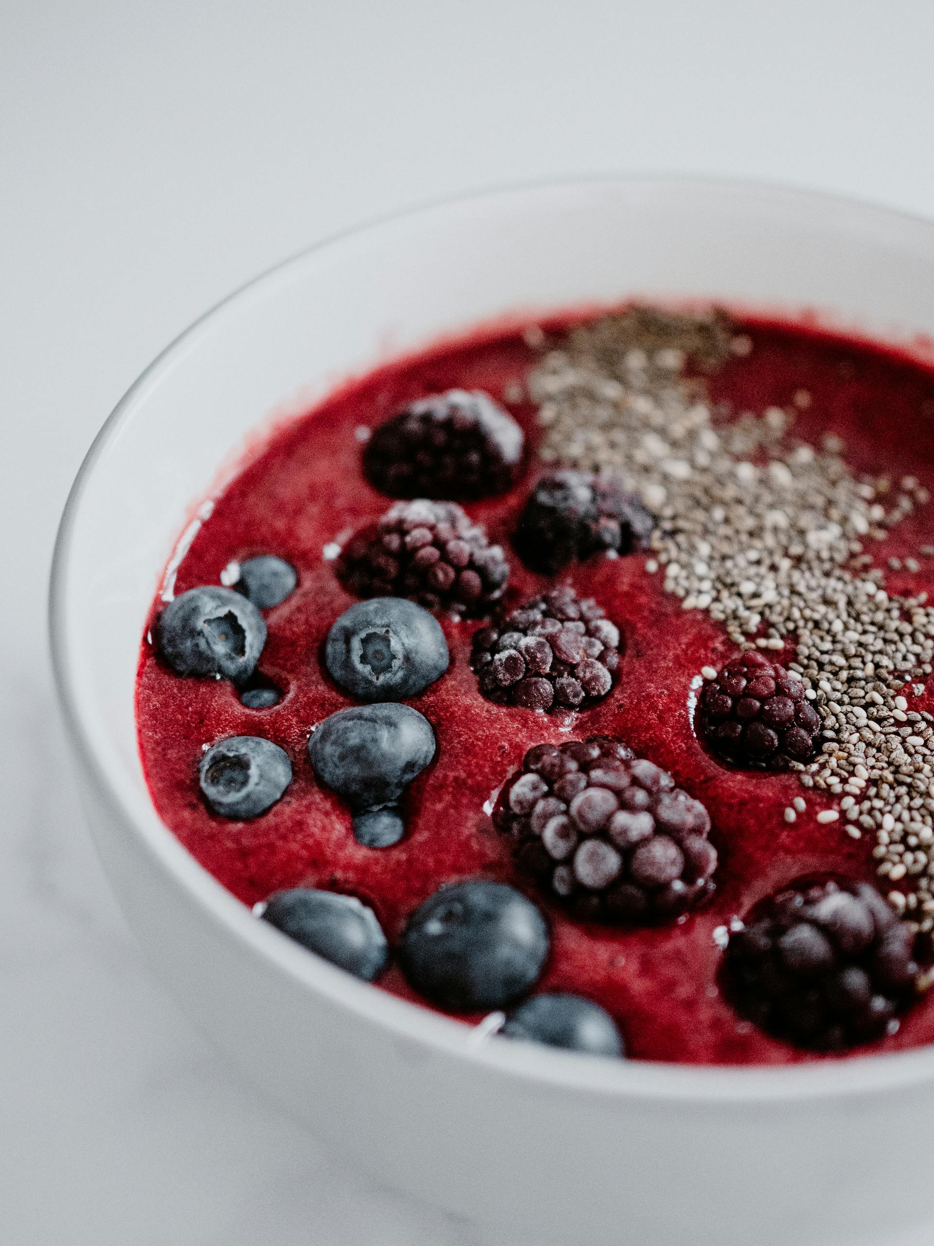 Fresh berry smoothie bowl with chia seeds, a healthy and colorful high-fibre food breakfast option.