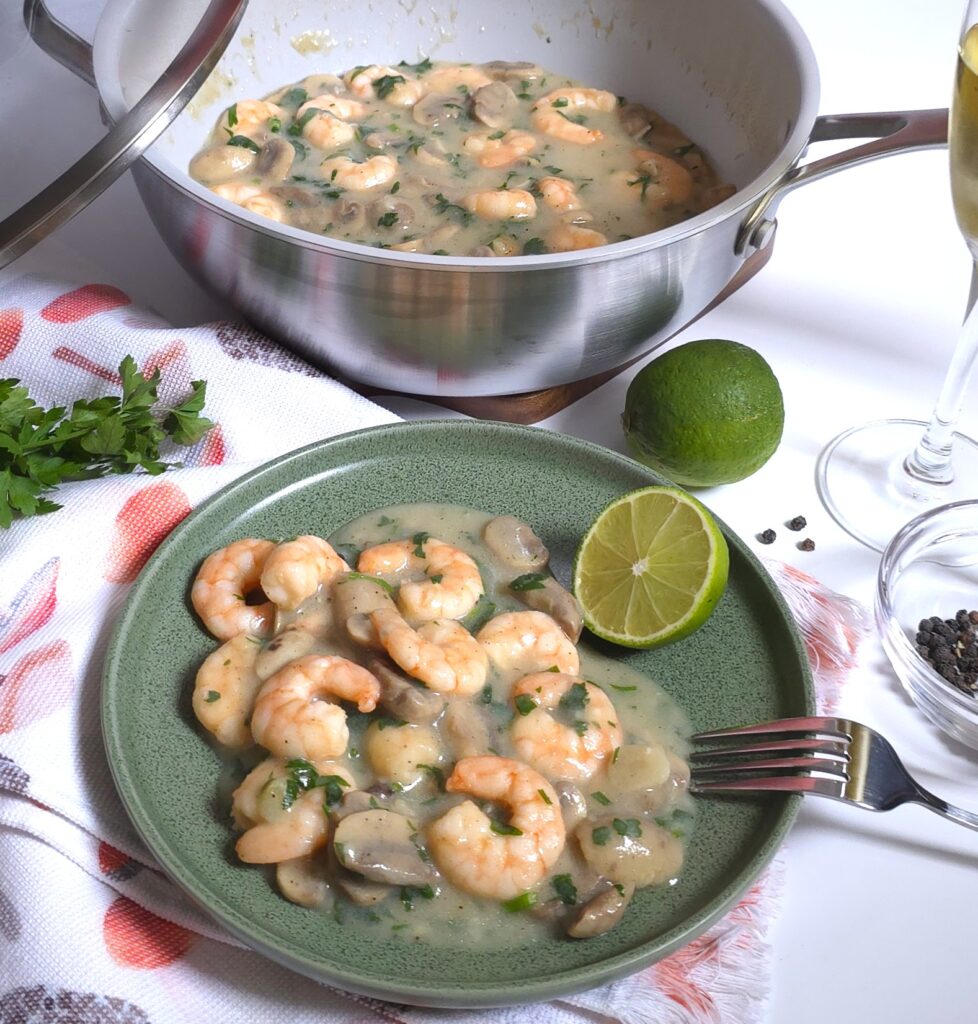 a green plate with garlicy mushroom prawns