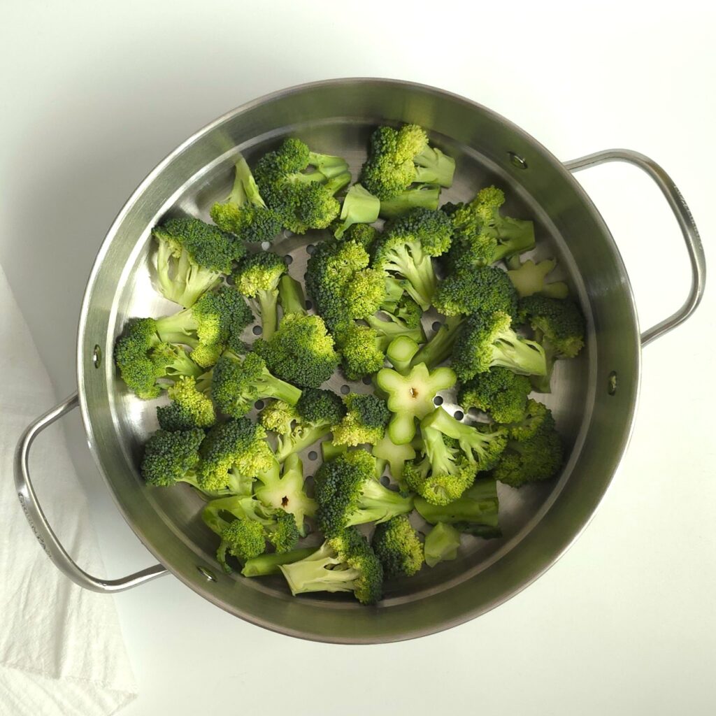 raw broccoli in a steaming basket