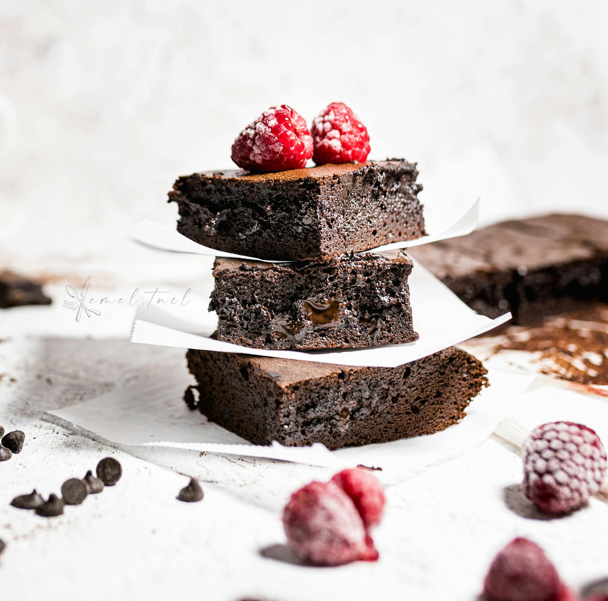 Delicious chocolate brownies topped with raspberries, perfect for dessert lovers.