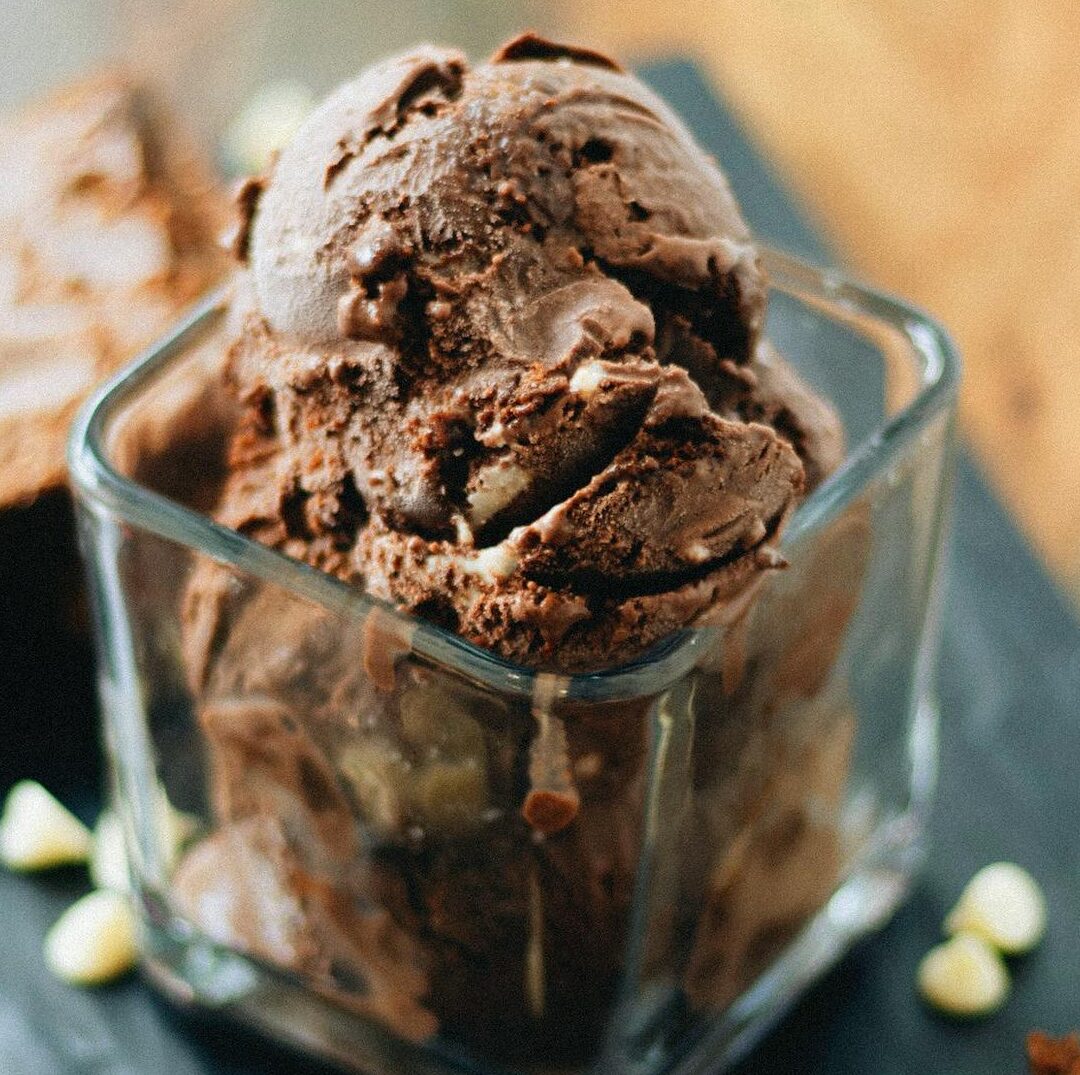Indulge in creamy chocolate ice cream served with rich brownie squares for a delightful treat.