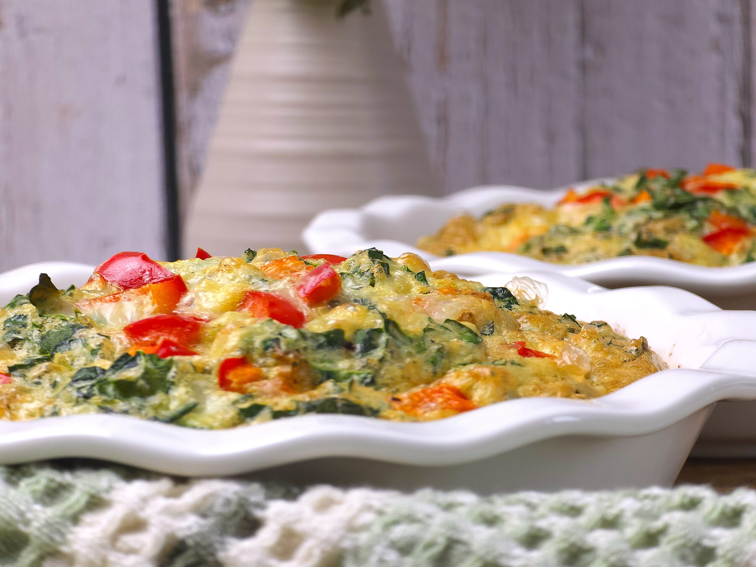 a close look of baked mini quiche in a white ceramic baking dish