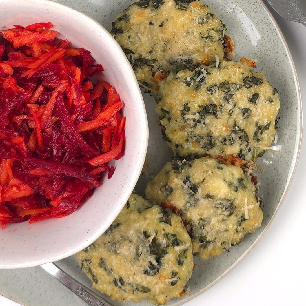 turkey kale cheesy patties in a plate next to a bowl with beetroot salad