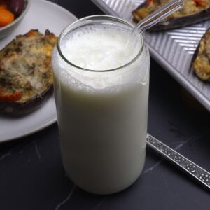 a glass with fresh ayran probiotic drink and glass straw