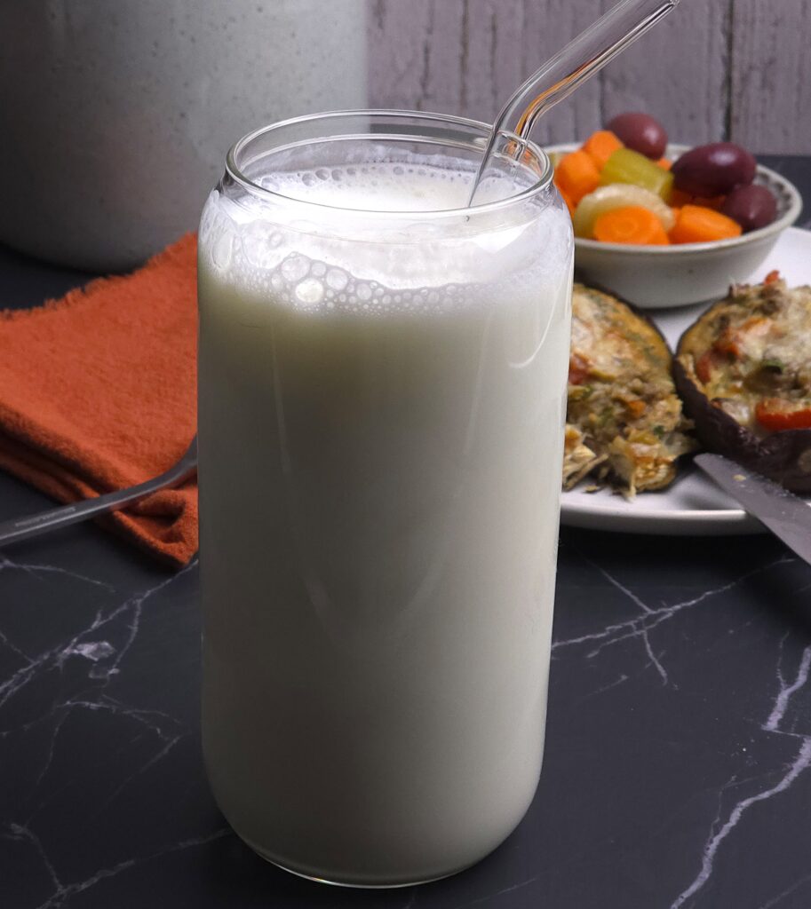 a glass with fresh probiotic yoghurt drink ayran and glass straw