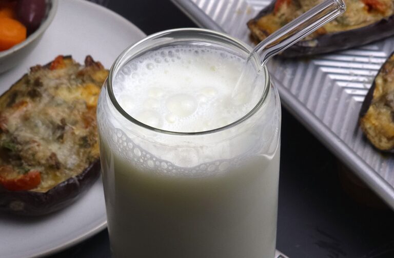 a close look of ayran in a glass and glass straw