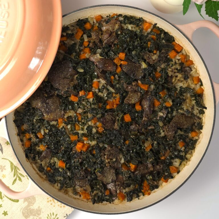 a cast-iron shallow casserole with chicken liver with rice and vegetables