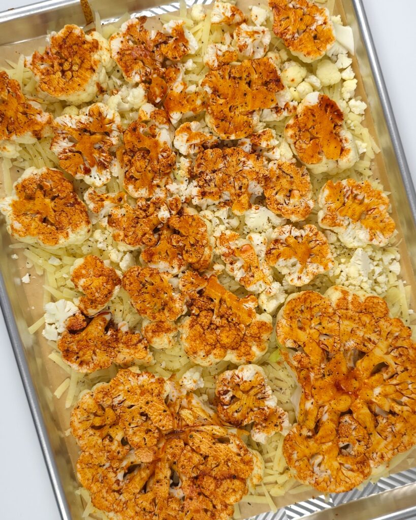 raw cauliflower steaks in a baking tray