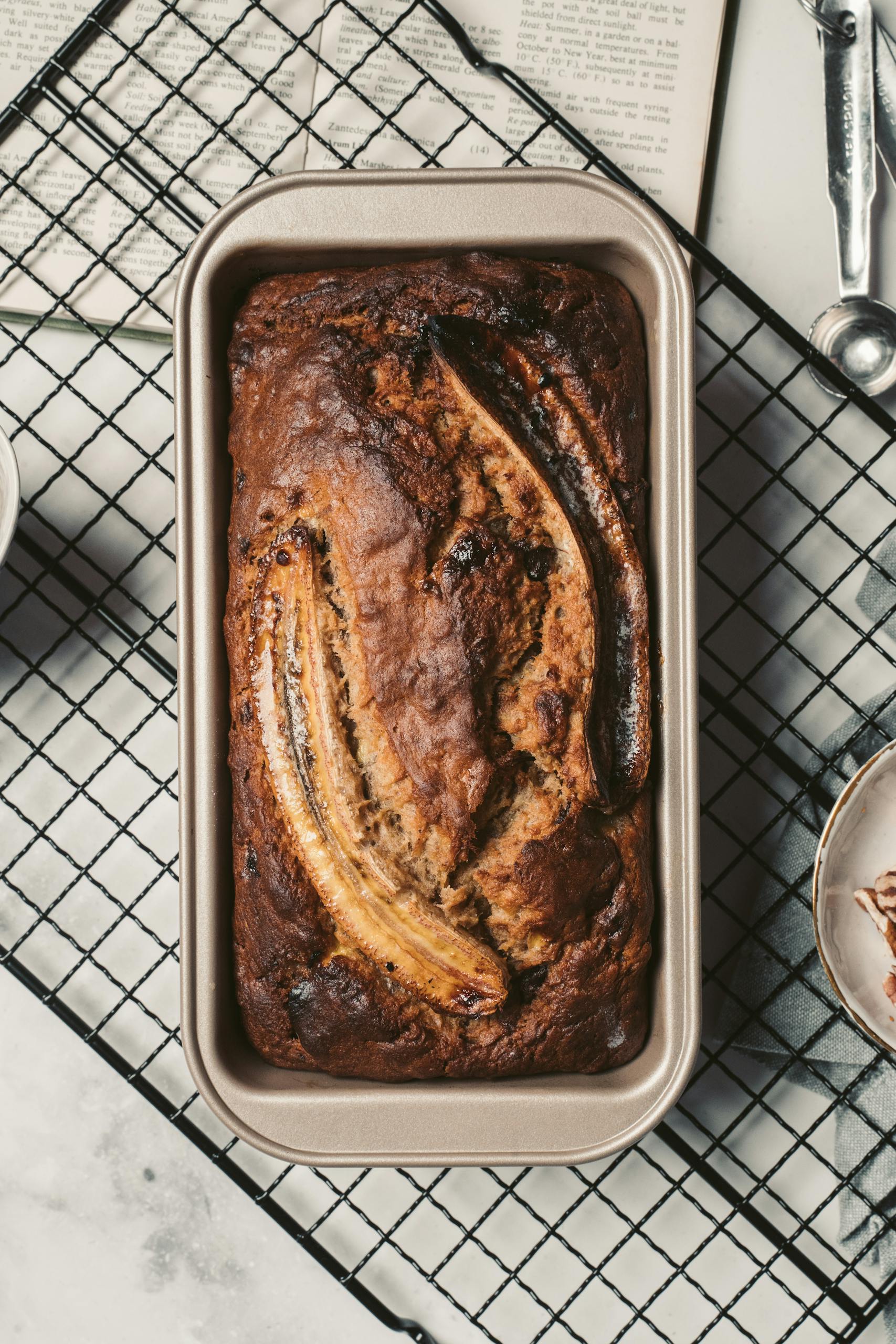 Top view of a delicious homemade banana bread fresh from the oven placed on a cooling rack. Enjoy the warm and inviting aroma.