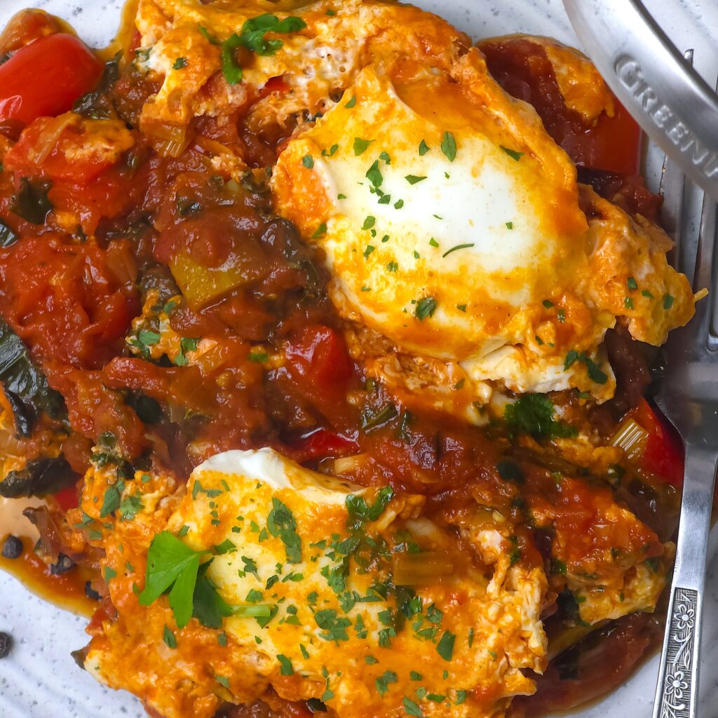 a close look of a vibrant, gluten-free, lactose free, one-pan  shakshuka in a plate