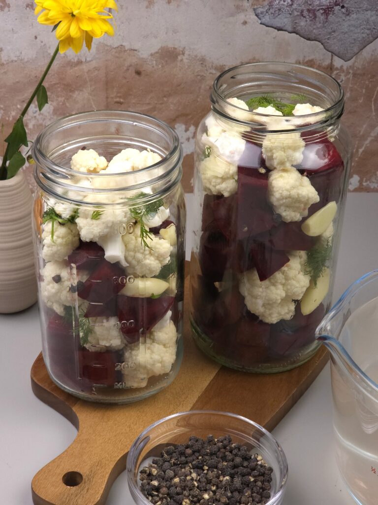 chopped beetroot and cauliflower in jars