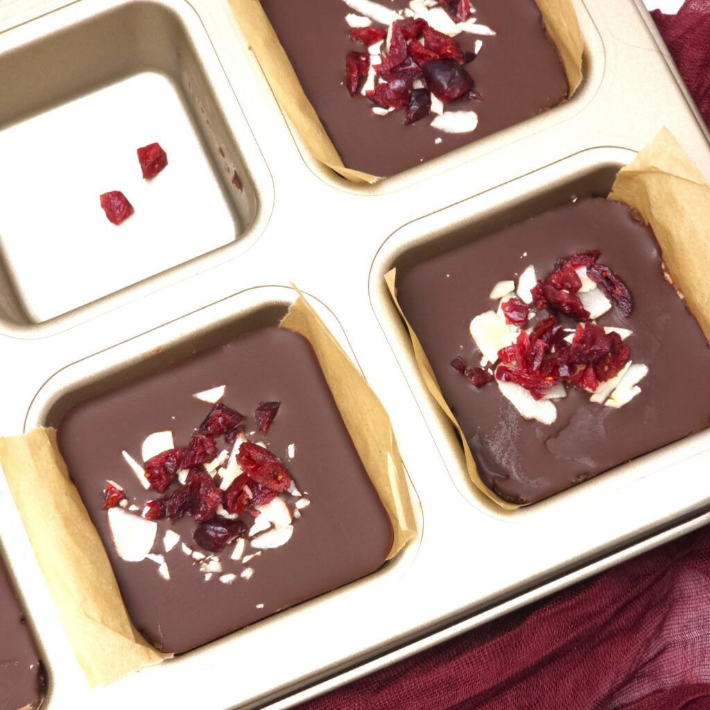 no bake gluten-free almond cranberry chocolate bars in a tin 