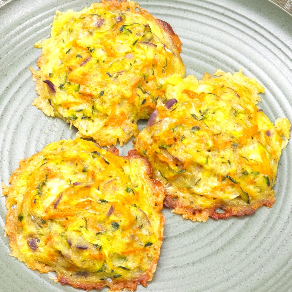 Golden zucchini parmesan fritters on plate