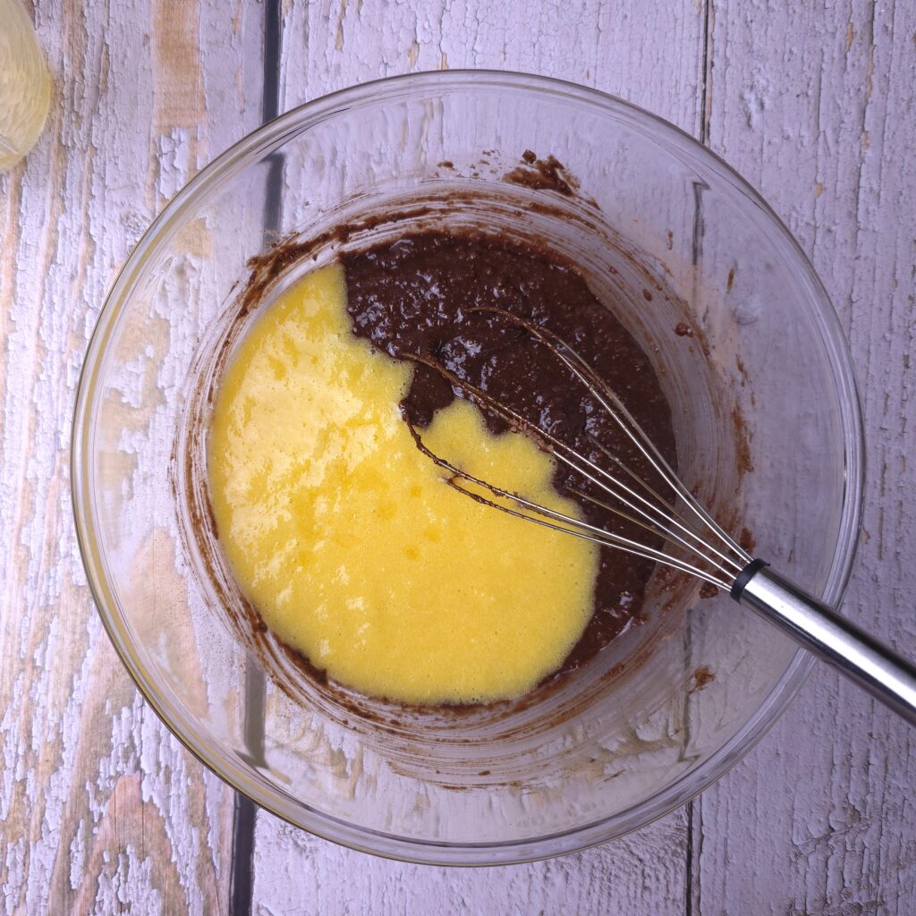 Mixing chocolate batter and orange puree for chocolate orange cookies