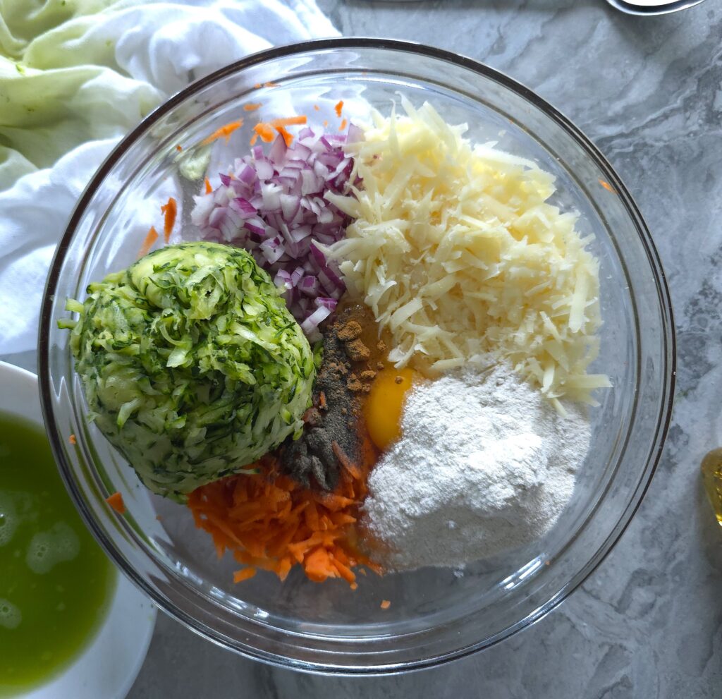Bowl of mixed fresh ingredients for zucchini parmesan fritters