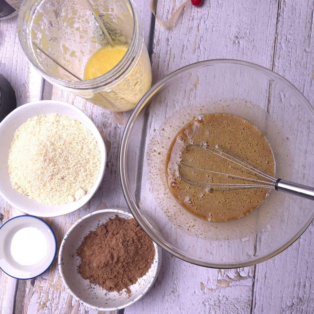 Ingredients for baking preparation - whisked eggs with sugar, vanilla and olive oil