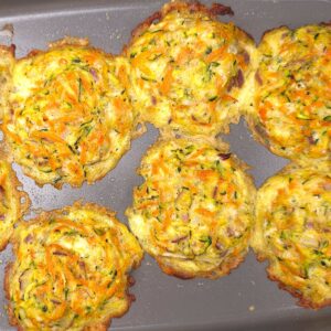 Golden-brown zucchini parmesan fritters on tray