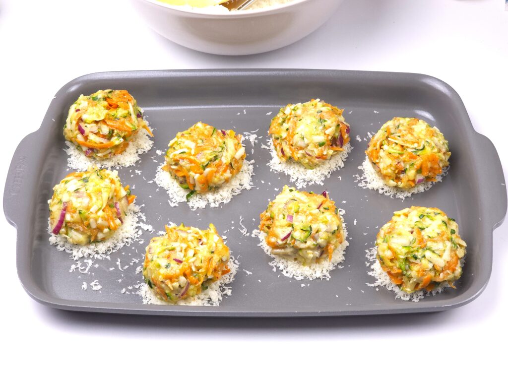 Zucchini parmesan fritters on a baking tray