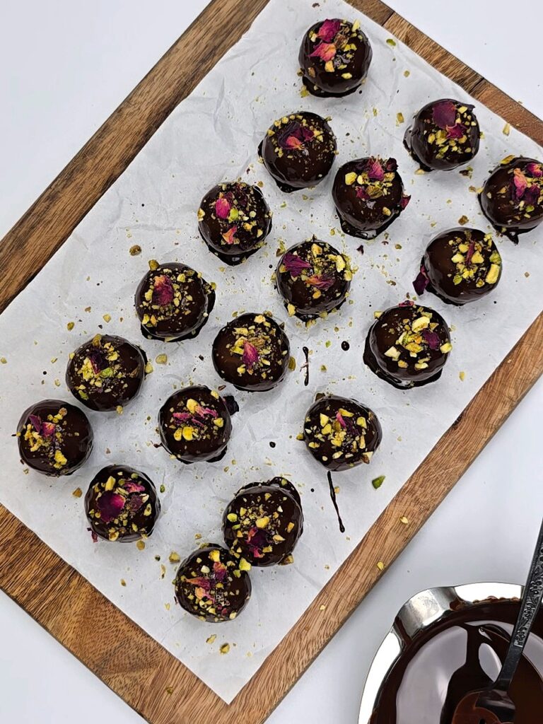 energy balls sprinkled with chopped pistachio and edible rose petals