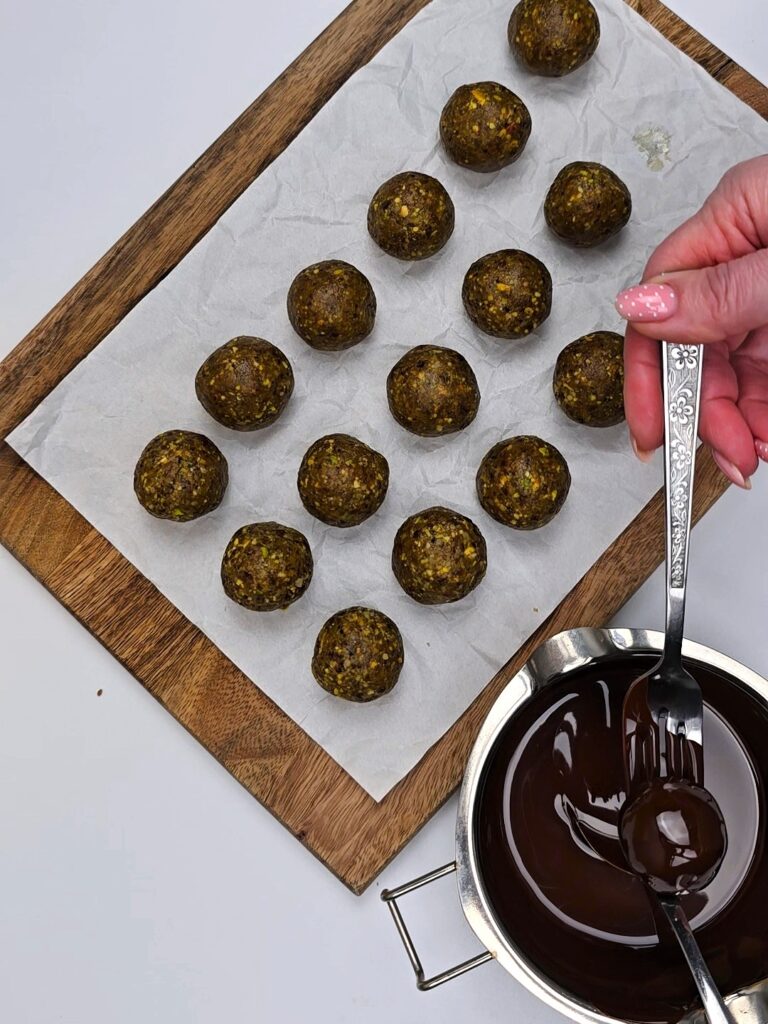 coating the energy balls with chocolate