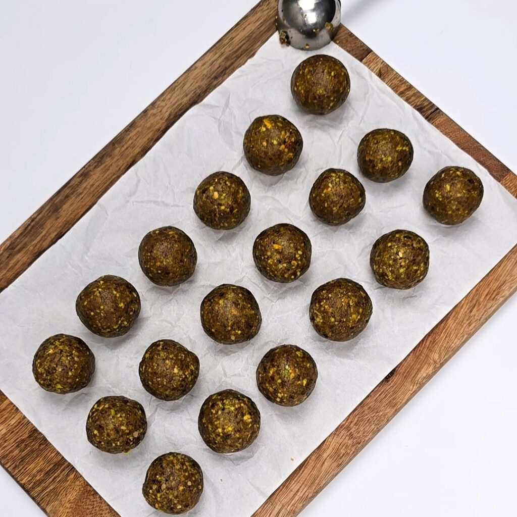 formed energy balls on parchment paper