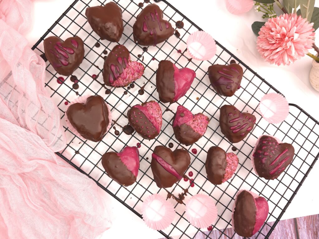 Heart-shaped vegan chocolate raspberry valentines with pink decorations