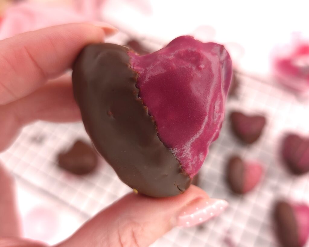 Close look of chocolate-covered gluten-free raspberry heart-shaped sweet treat