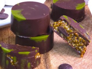 A close look of gluten-free Dubai chocolate bonbons with pistachios and maple syrup