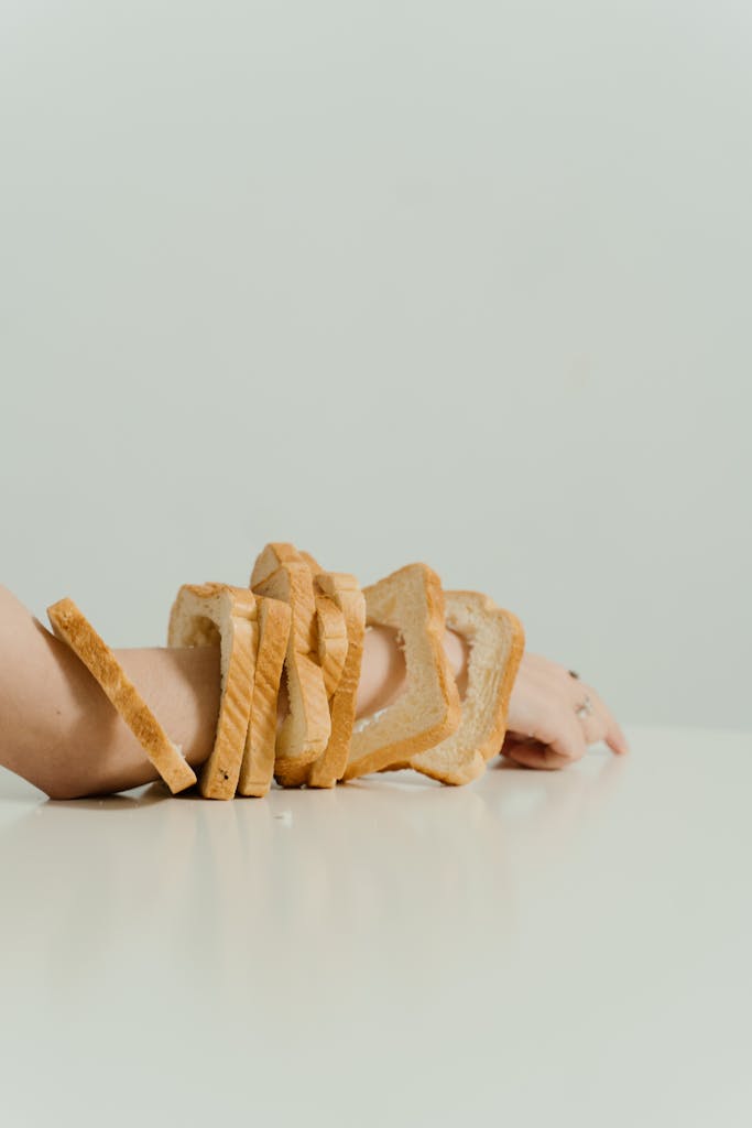 Artistic arrangement of bread slices on an arm creating a unique newly diagnosed celiacconceptual look.
