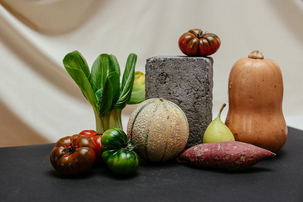 A colorful assortment of fresh vegetables and fruits arranged creatively on a table as a part of whole food matrix conception.