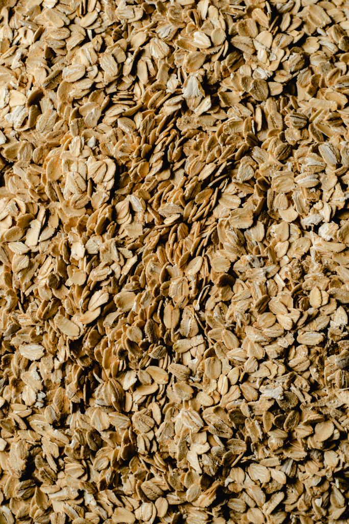 A detailed close-up view of textured rolled oats, ideal for food and health themes, such as are oats gluten-free.